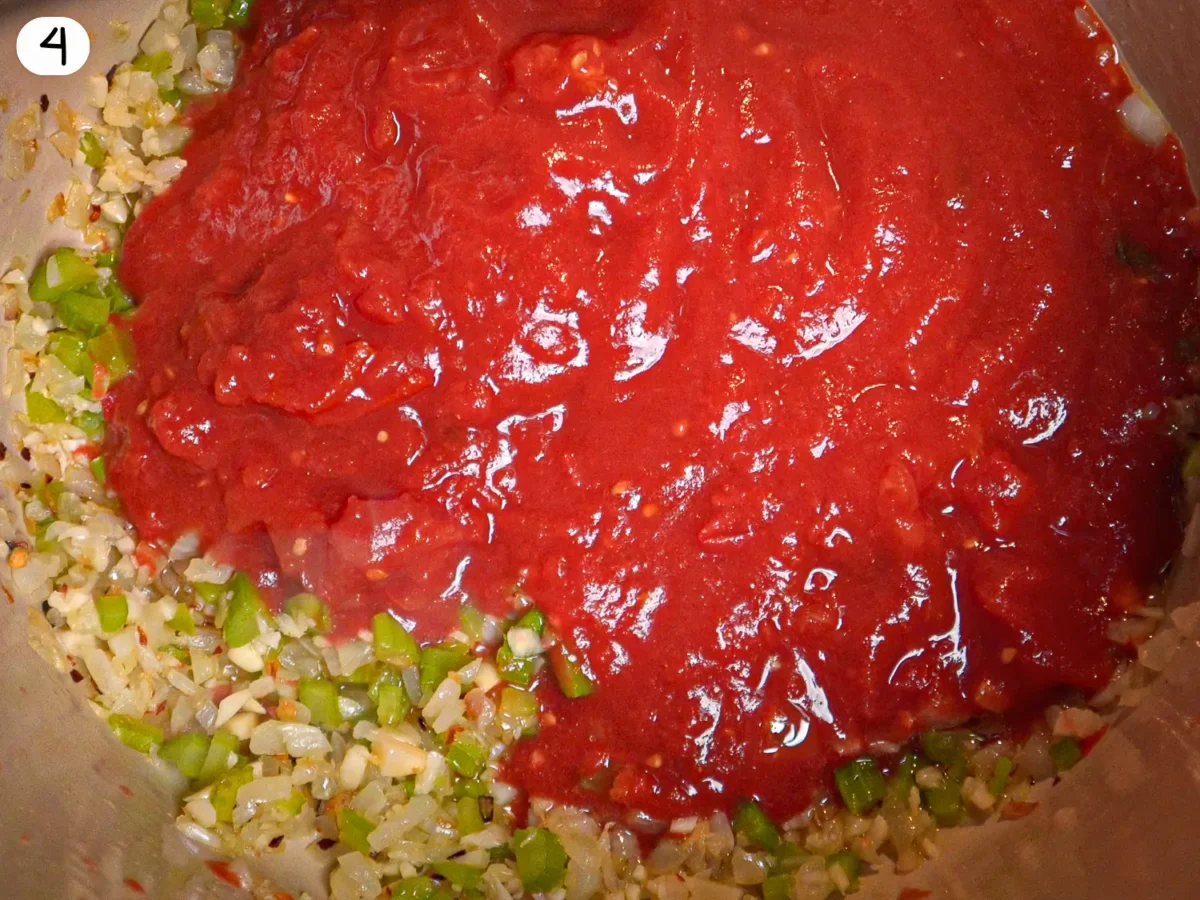 step 4 photo showing tomatoes being added to the pot