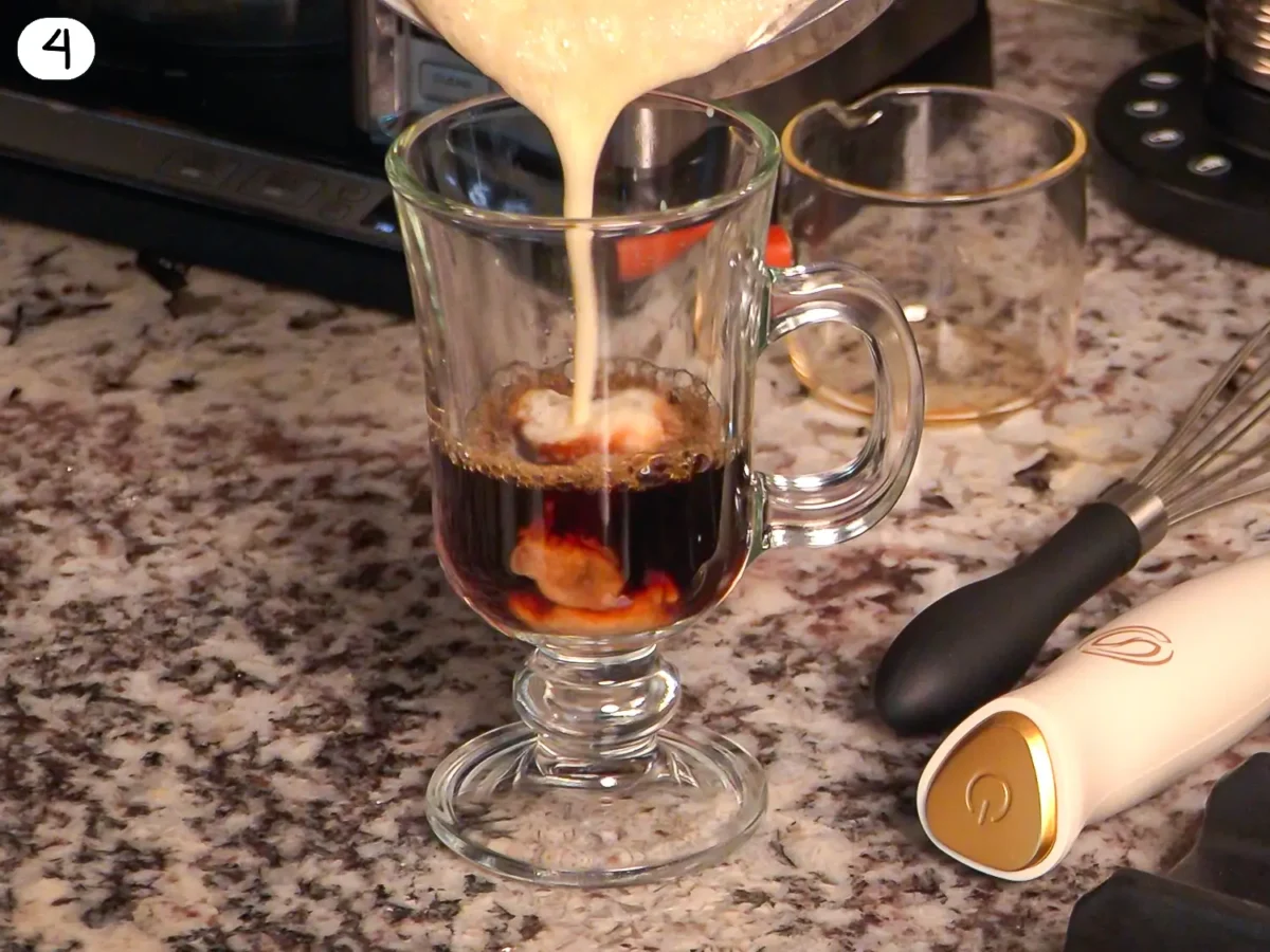 step 4 photo showing warm eggnog being poured over espresso