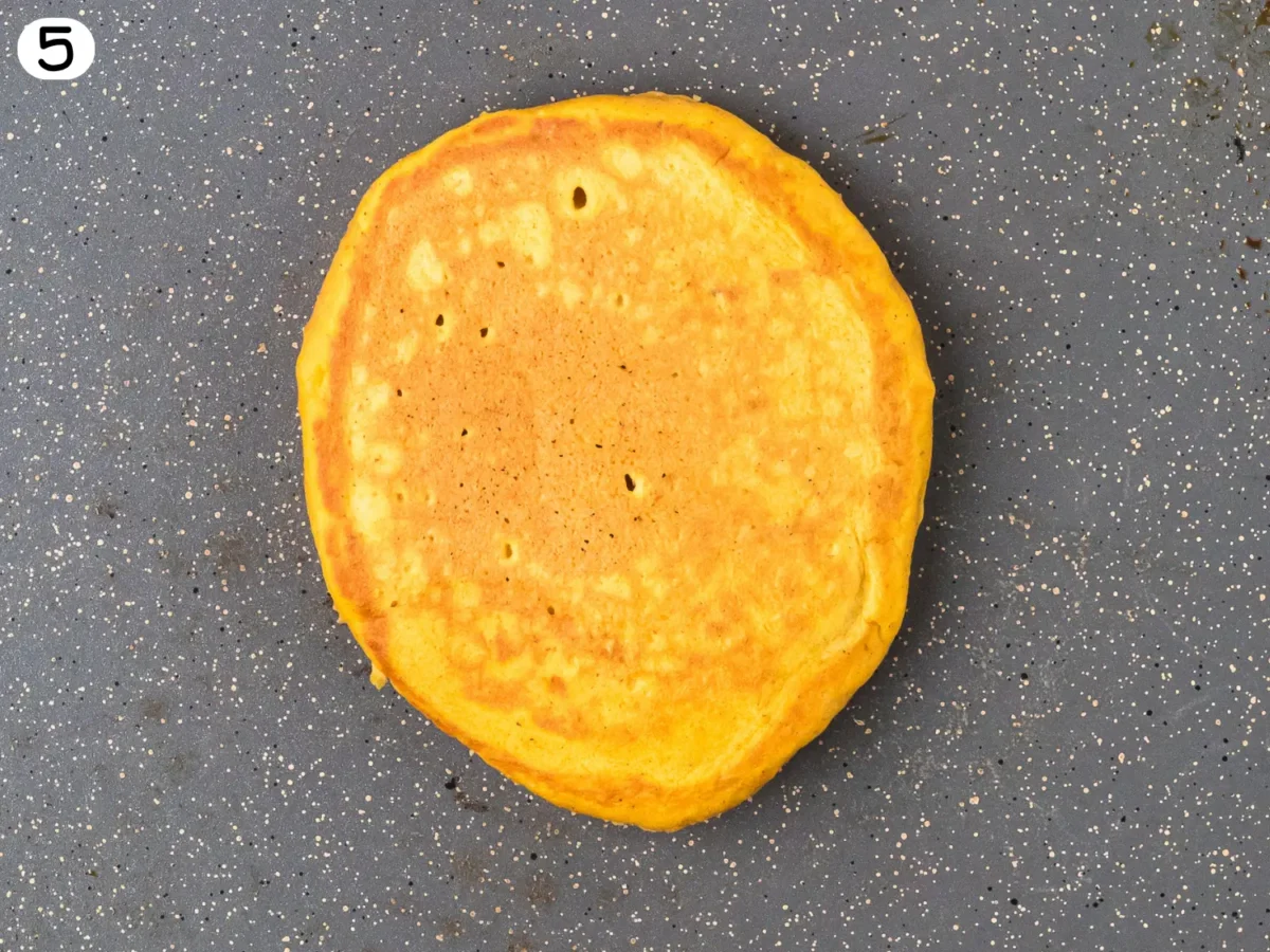 step 5 close up photo showing the pancake after it has been flipped