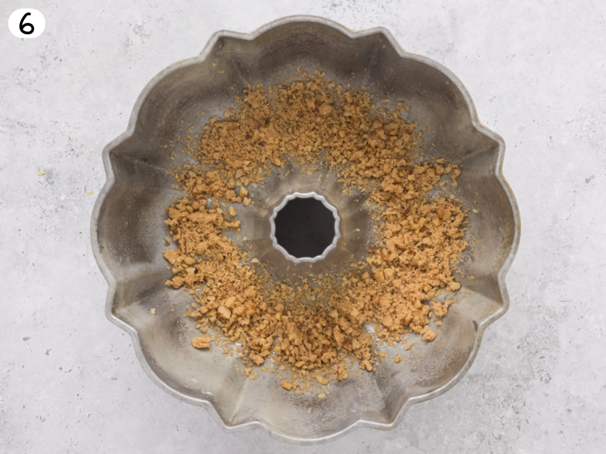 step 6 photo showing walnuts and brown sugar in the prepared bundt pan
