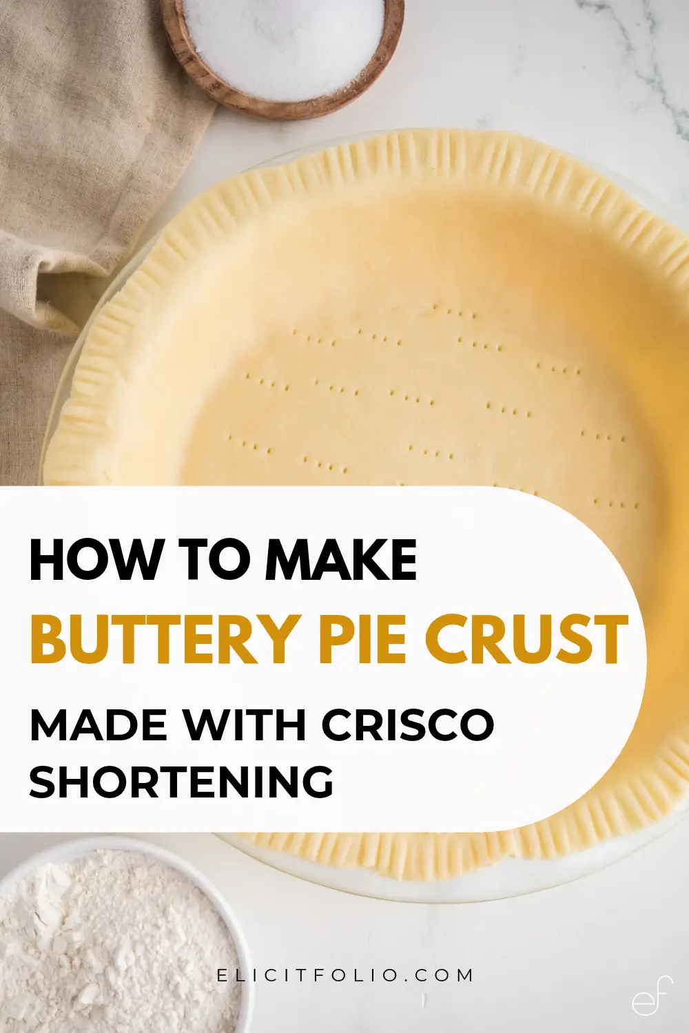 Overhead view of an unbaked Crisco pie crust in a glass pie dish with fork holes and crimped edges, surrounded by flour and salt. Text overlay reads “How to Make Buttery Pie Crust Made with Crisco Shortening” with ElicitFolio.com at the bottom.