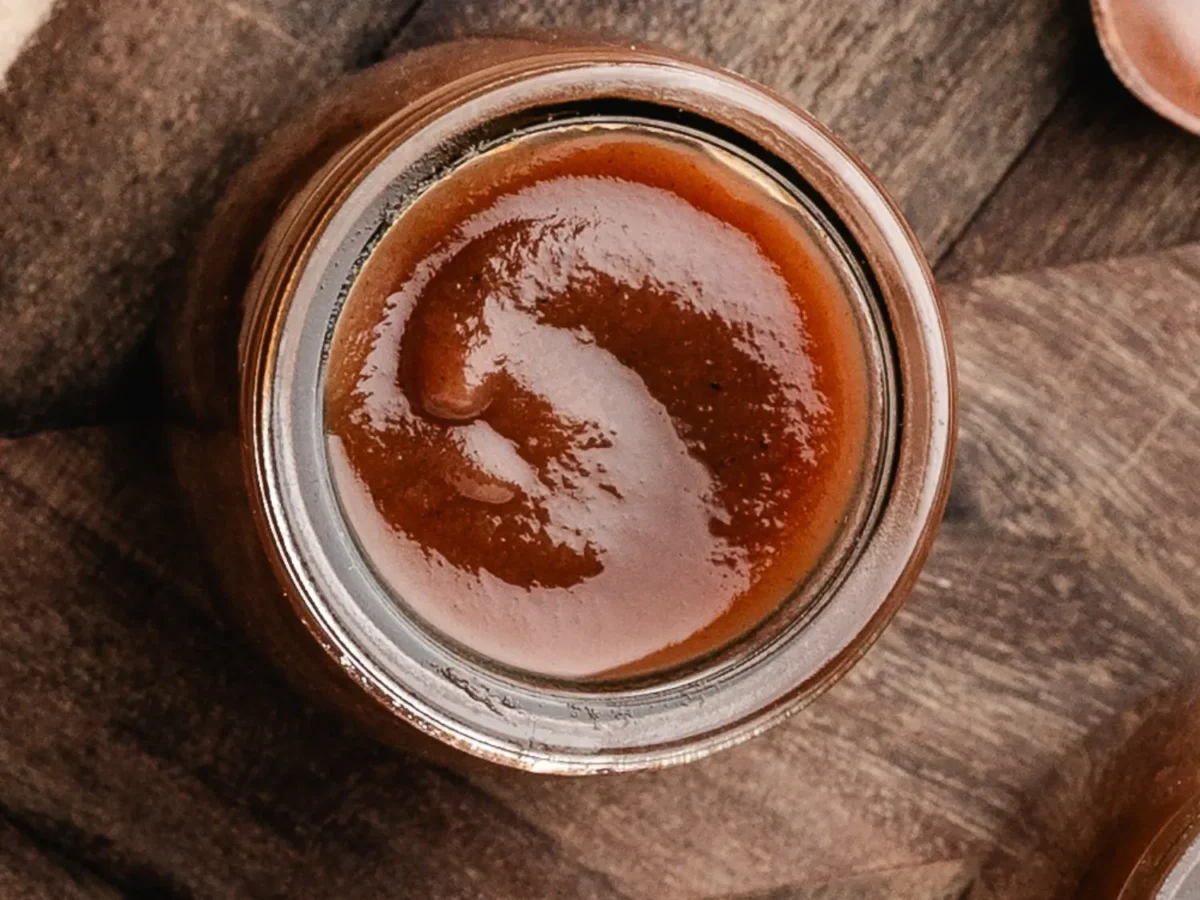 overhead photo of apple butter on a wooden cutting board