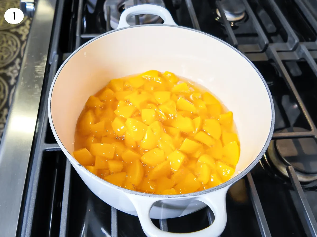 step 1 photo of canned peaches in a sauce pan