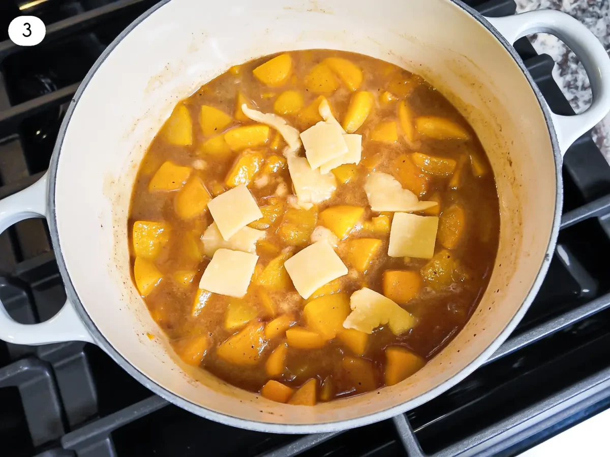 step 3 photo showing pieces of the homemade pie dough being added to the peach filling mixture
