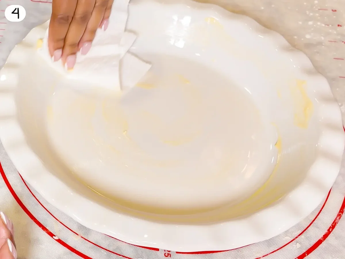 step 4 photo showing buttering the pie dish