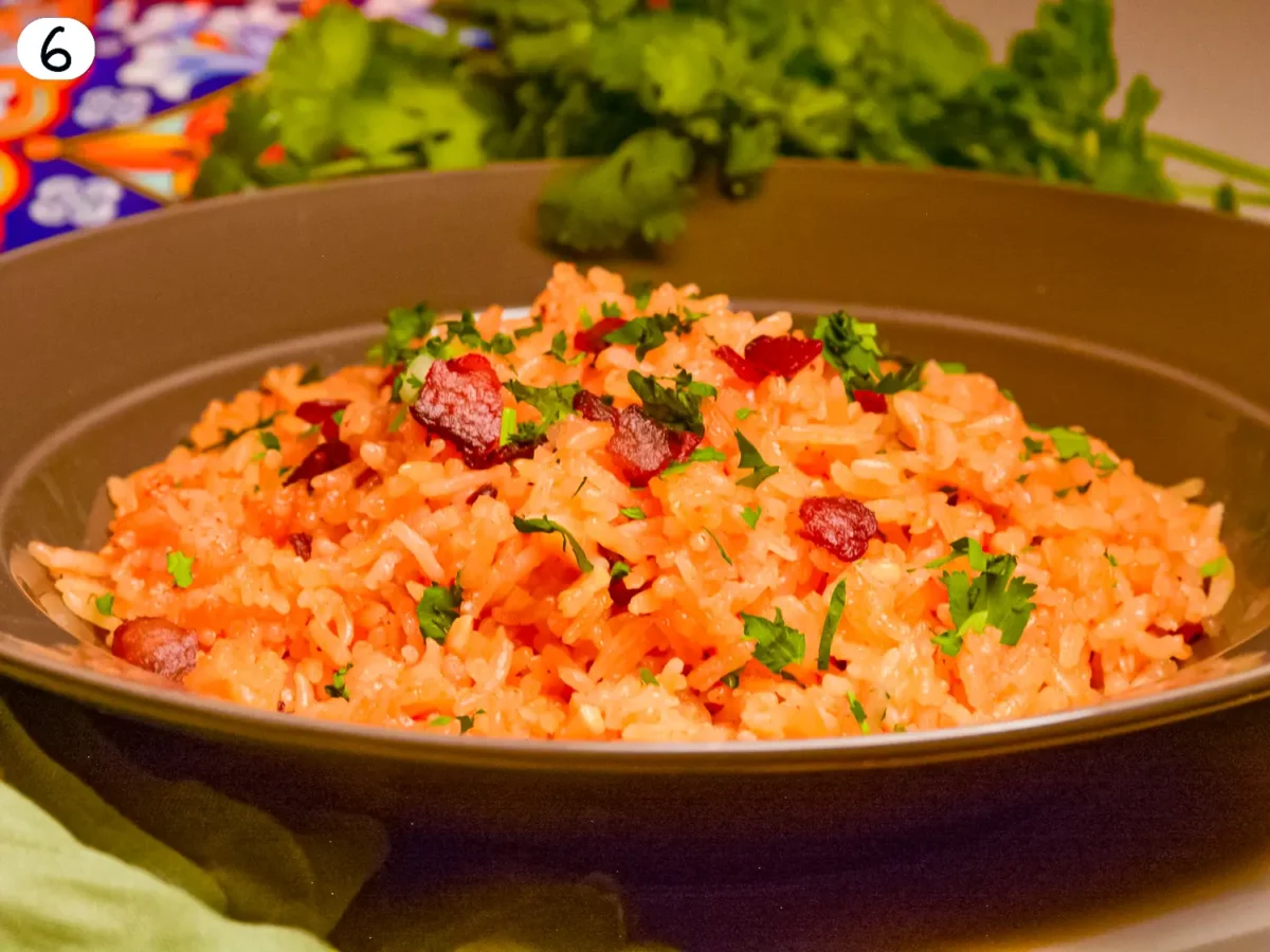 step 6 photo showing rice in a bowl topped with bacon and cilantro