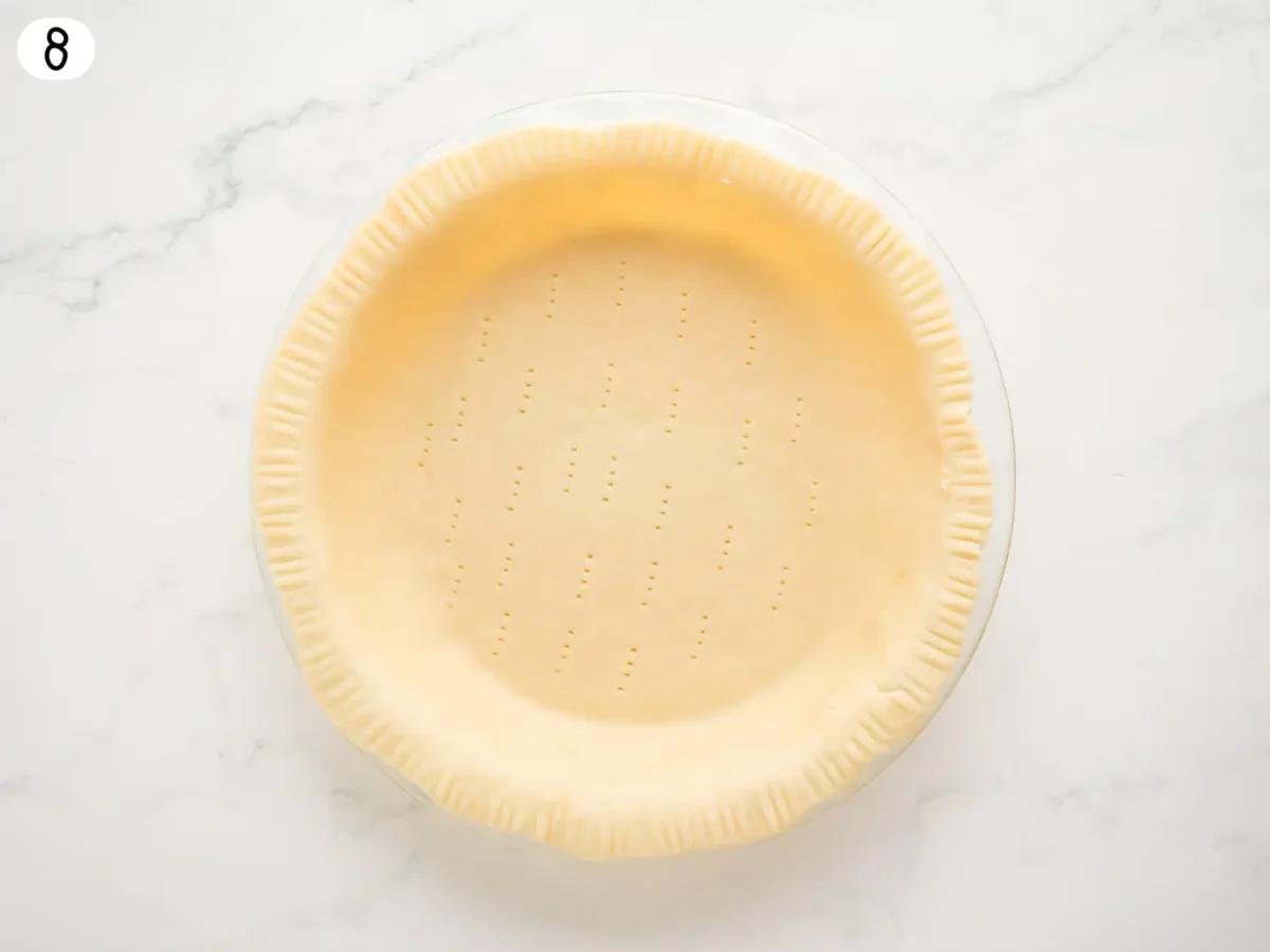 step 8 photo showing pie dough in a 9 inch baking dish