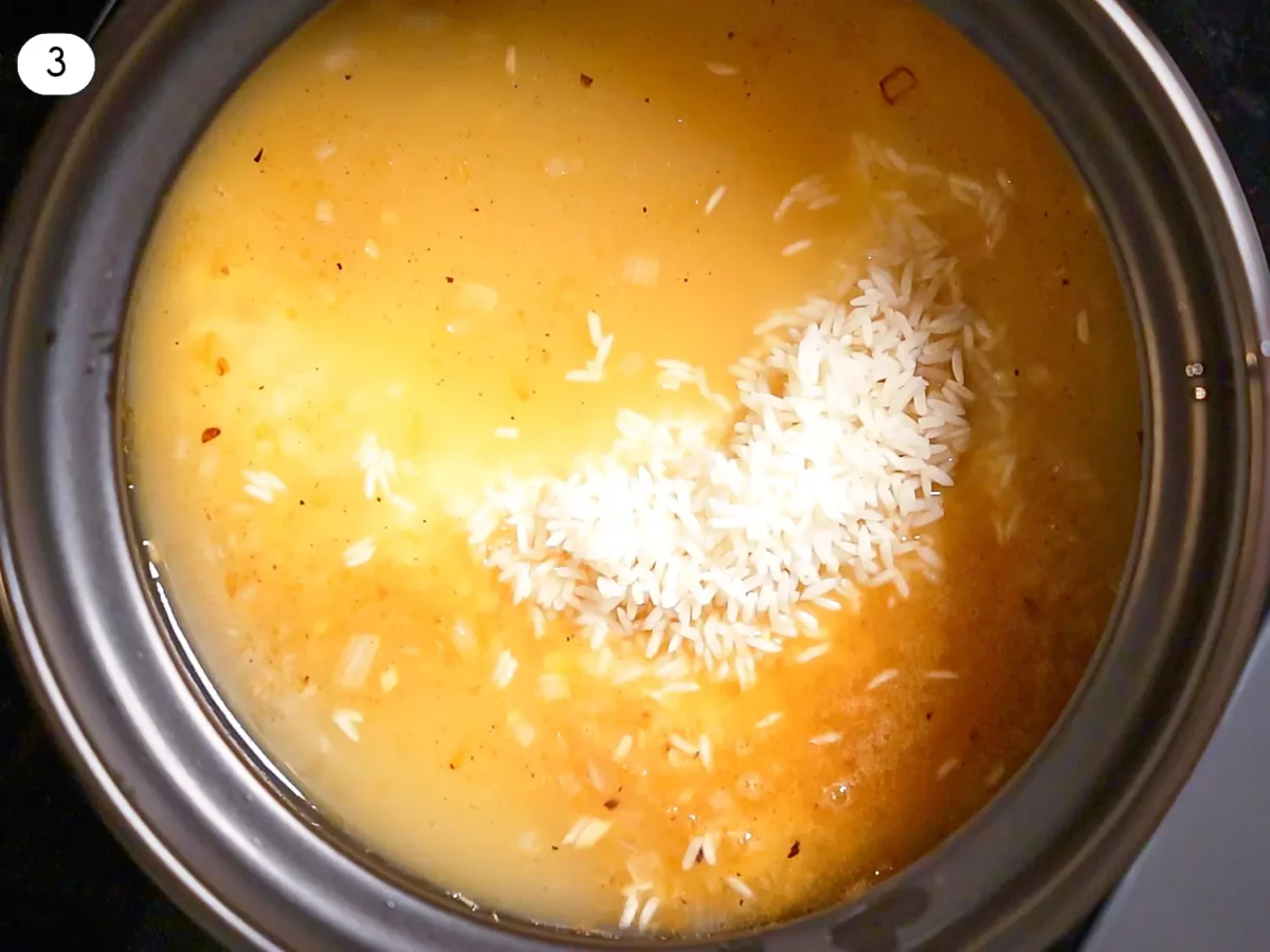 step three photo showing chicken broth that was added to rice in a pot